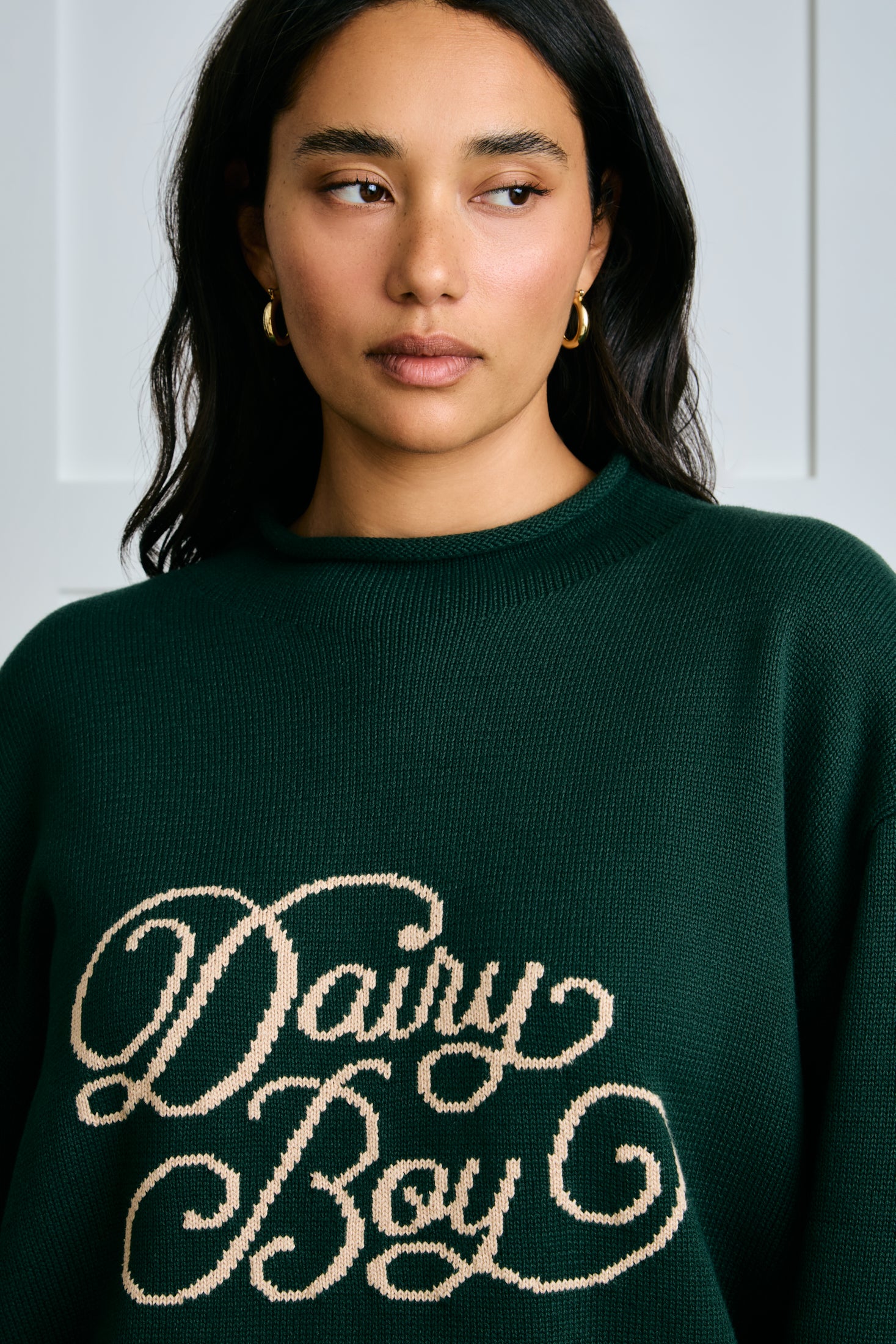 Person wearing a green sweater with 'Dairy Boy' text |m1