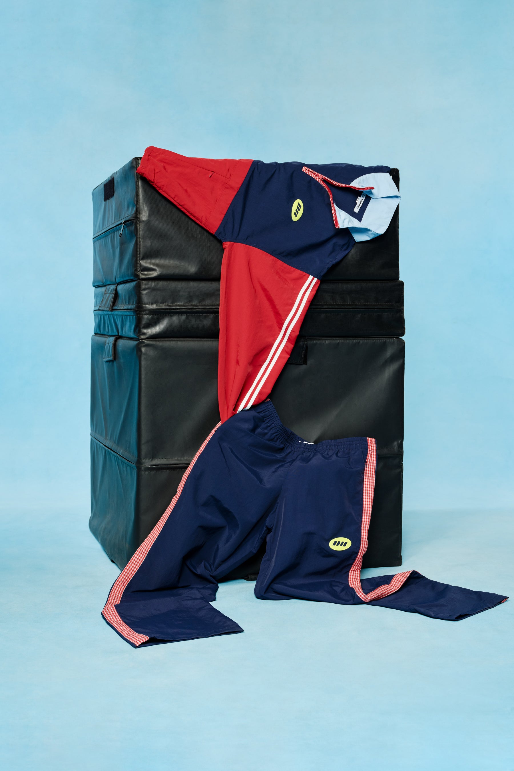 Navy and red sports outfit with visible branding on a blue background