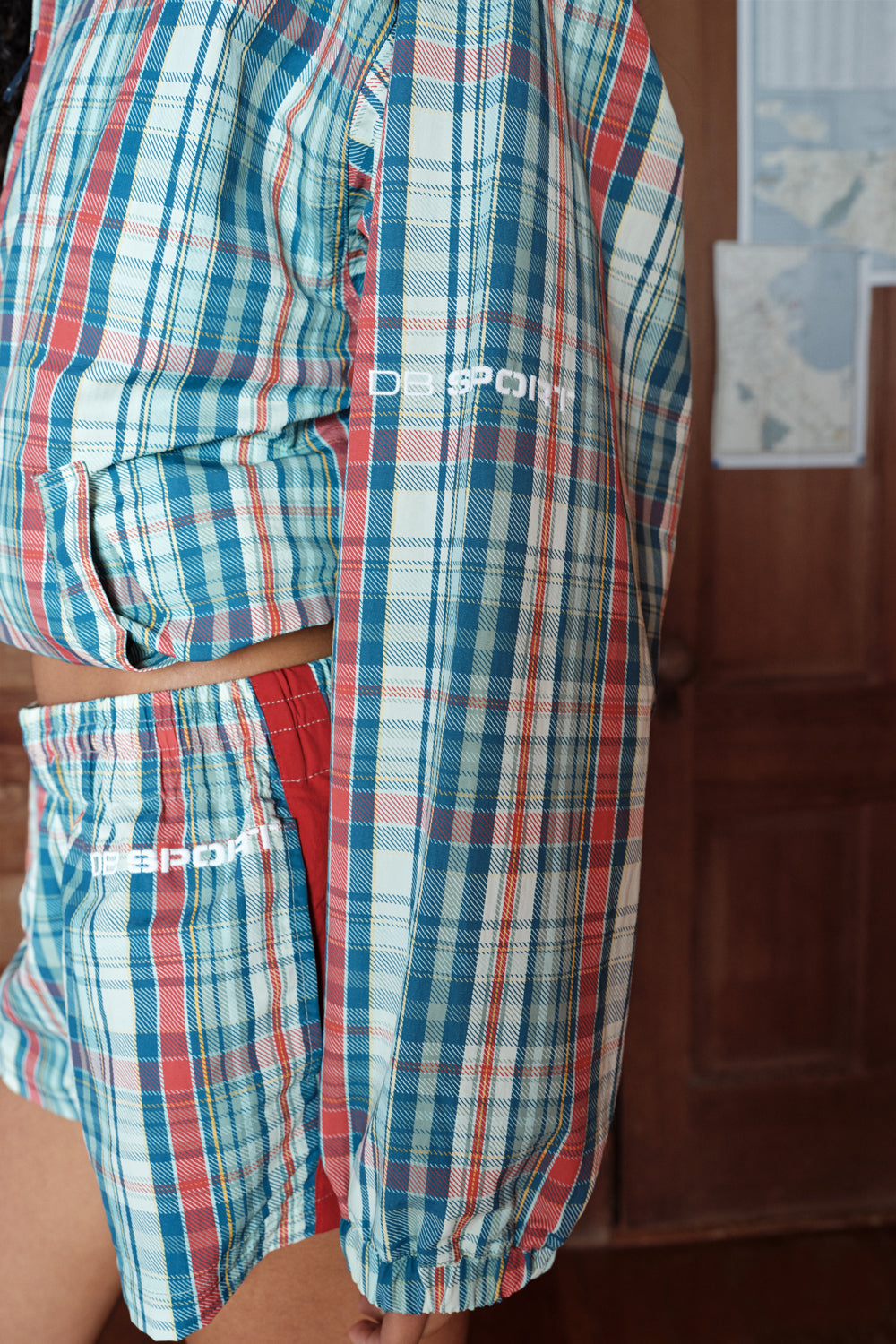 Plaid shirt and shorts with 'DB sport' branding on a plain background
|M1