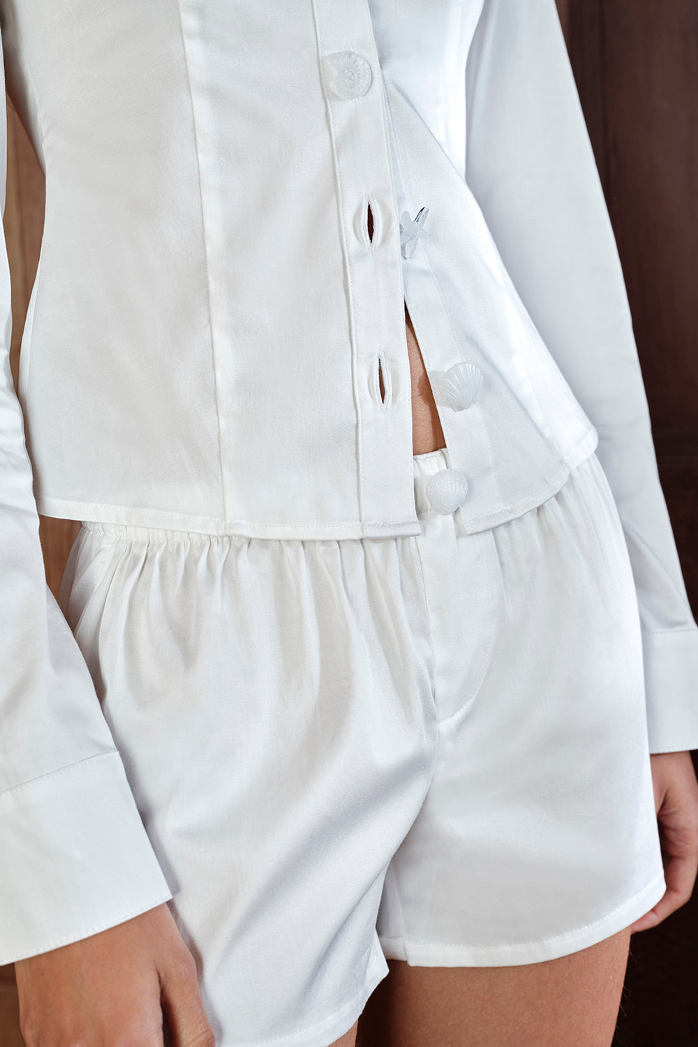 White shirt and shorts set on a plain background
|M1