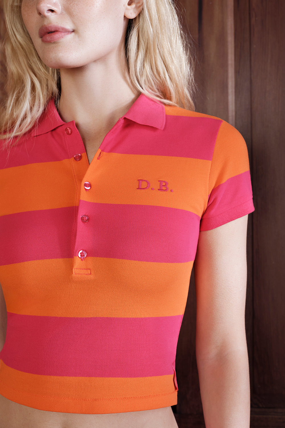Person wearing a red and orange striped polo shirt with 'D.B.' branding.
|M1
