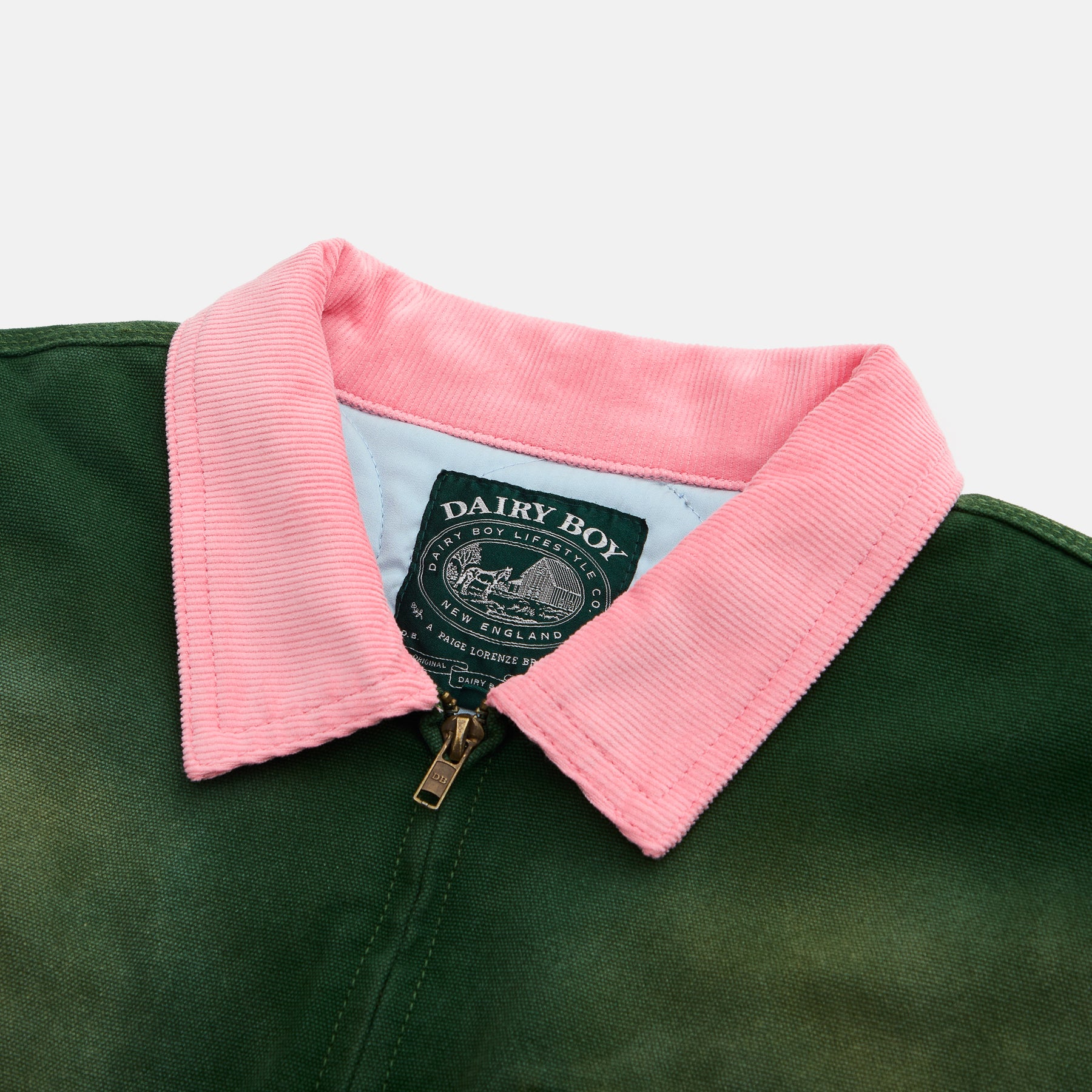 Green jacket with pink collar and 'Dairy Boy' label on a white background