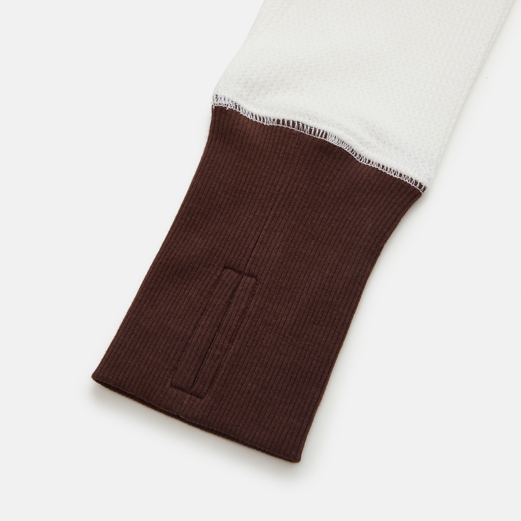 Brown ribbed sleeve cuff on a white background