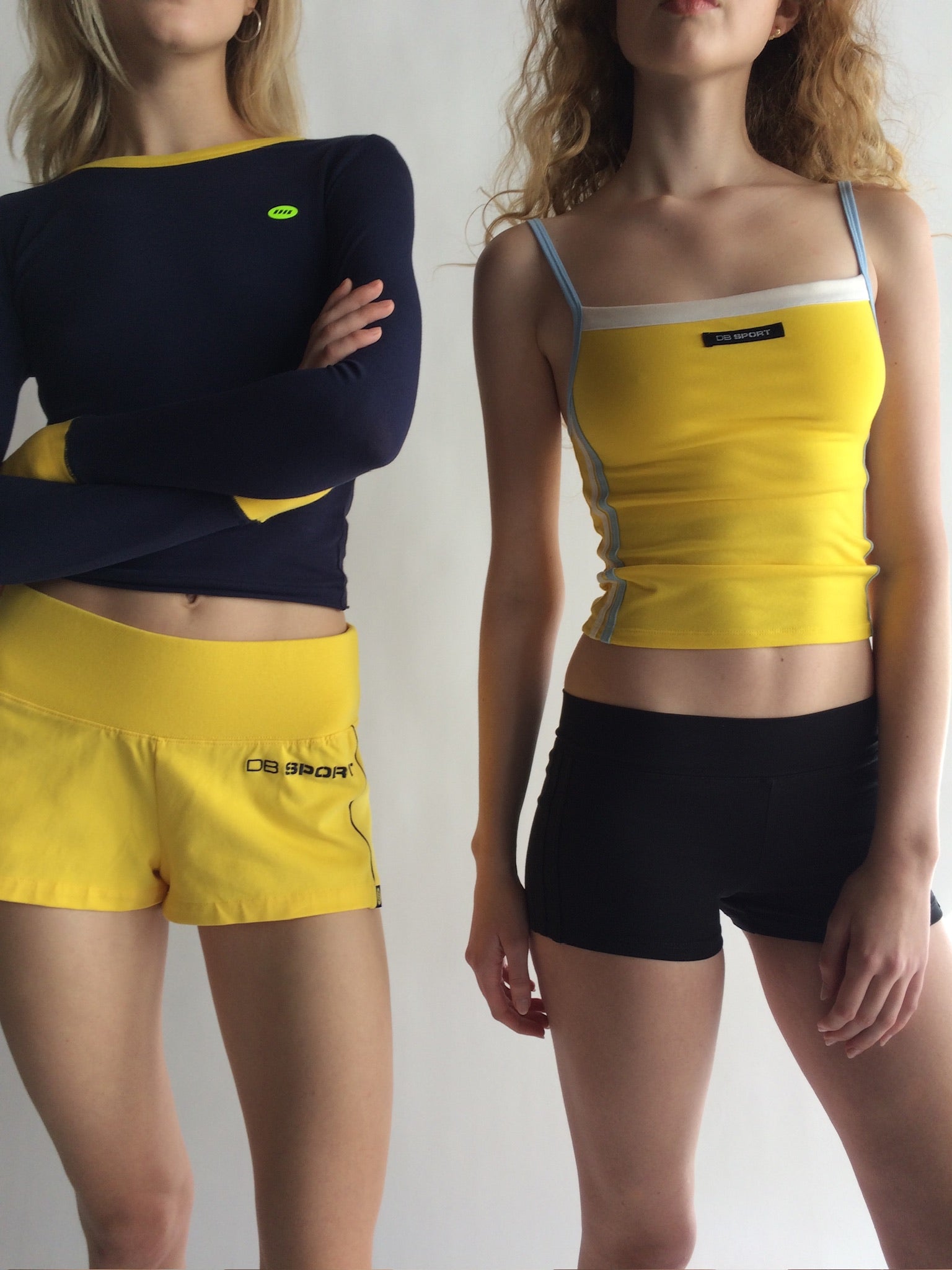 Two people wearing yellow and black athletic outfits with visible branding. |M1