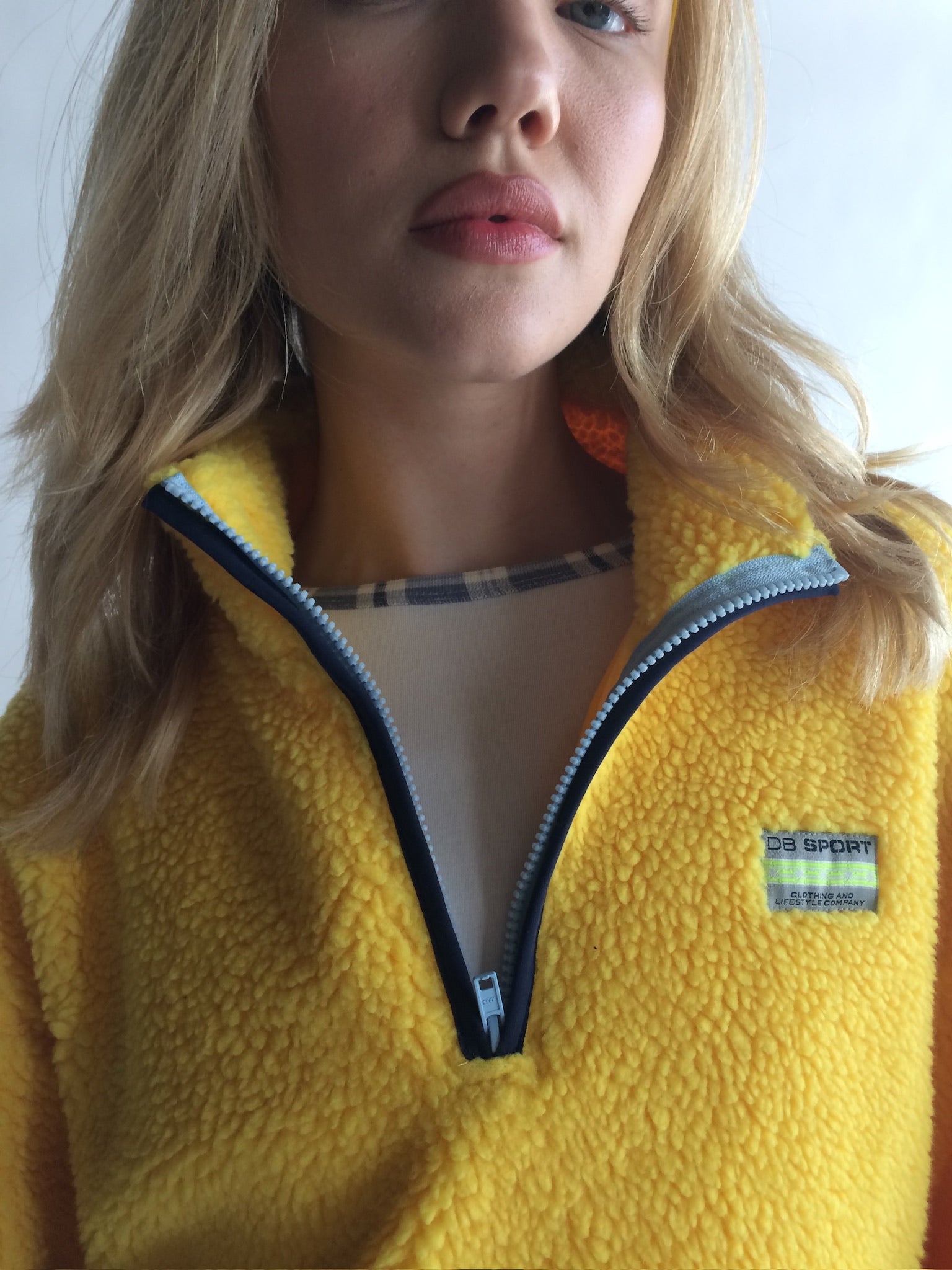 Person wearing a yellow fleece jacket with Patagonia logo |M1