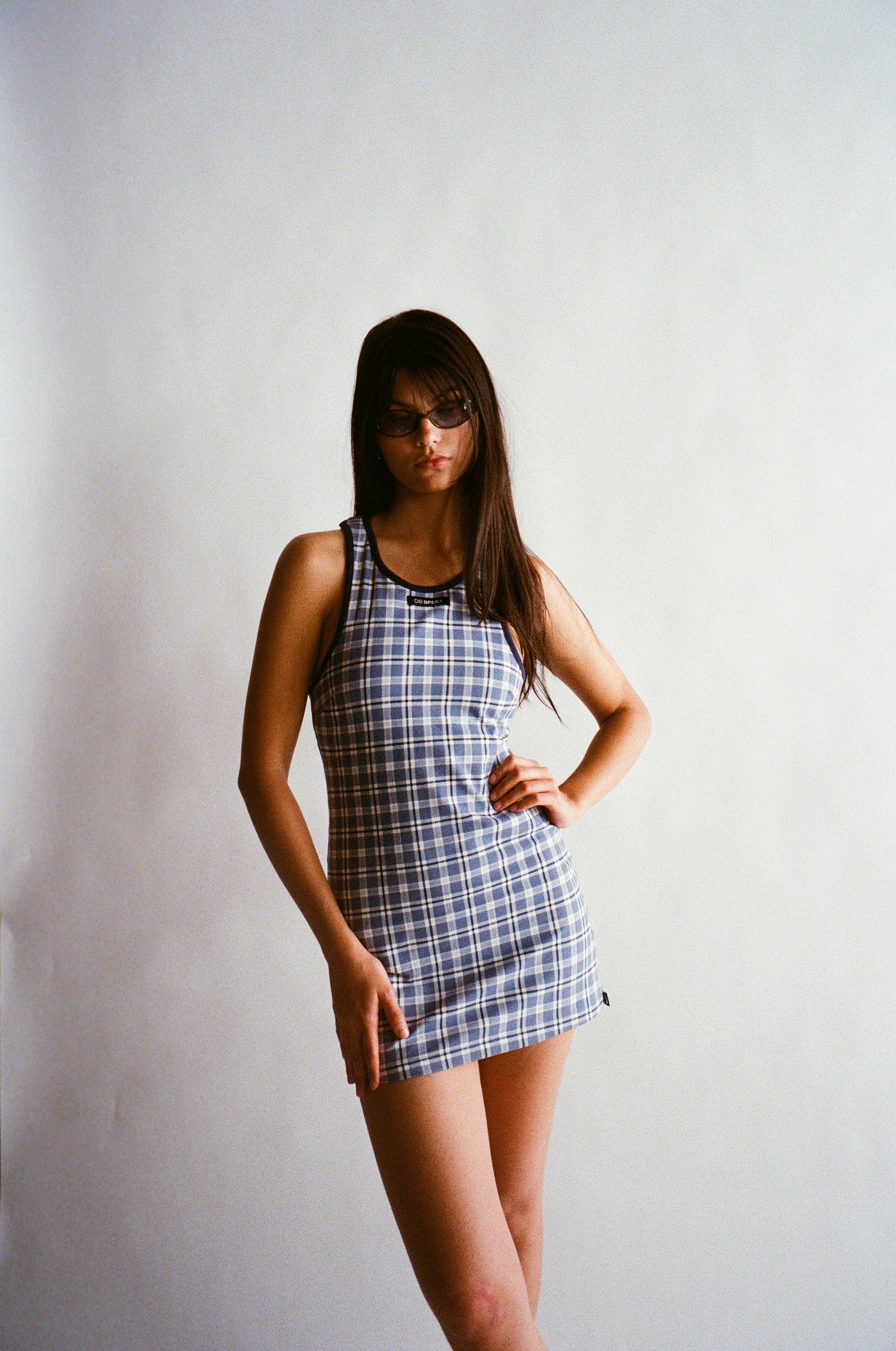 Woman wearing a plaid dress against a plain background |M2