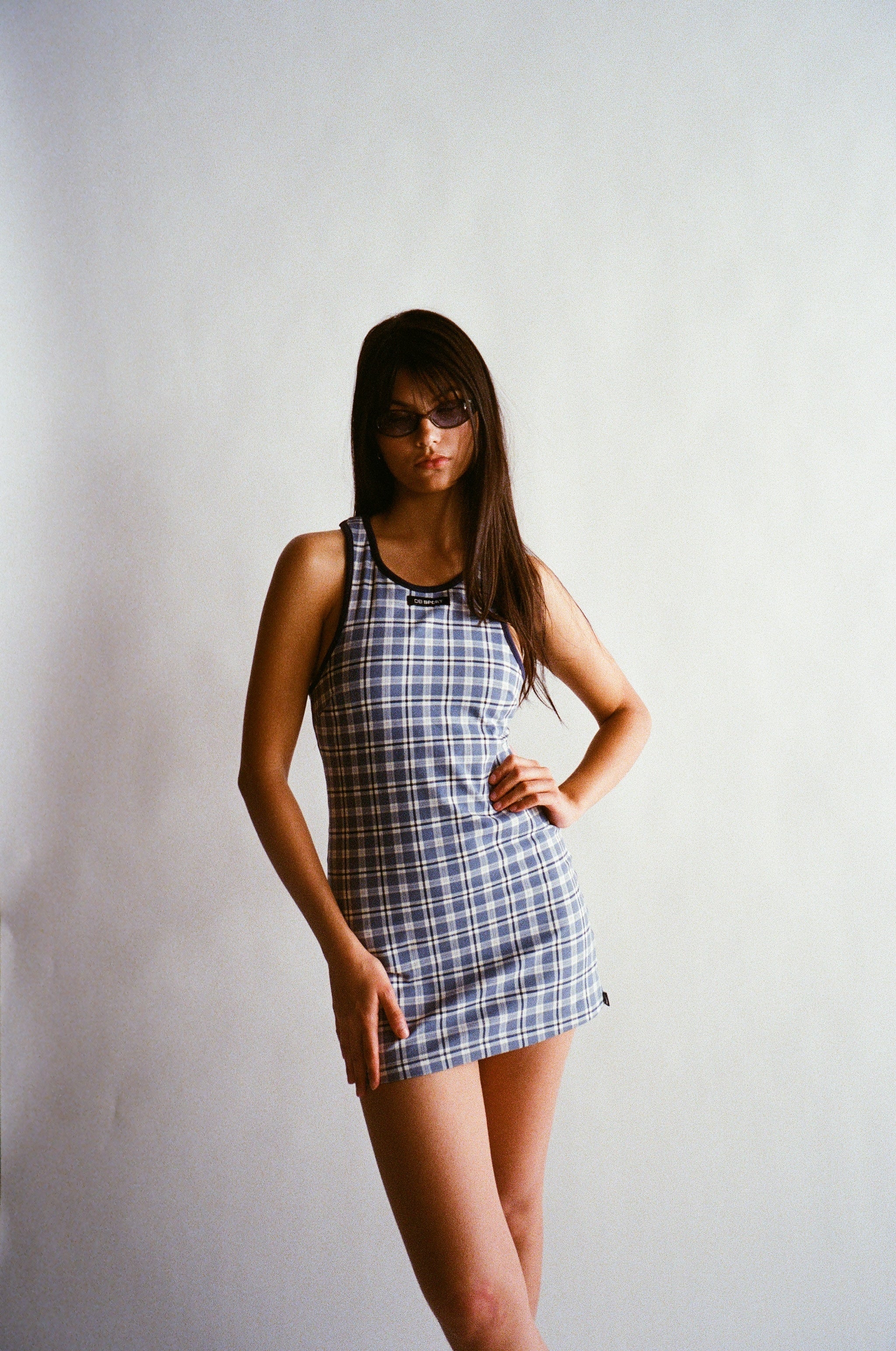 Woman wearing a plaid dress against a plain background |M2