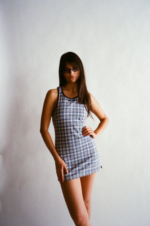 Woman wearing a plaid dress against a plain background |M2