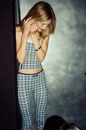 Woman wearing a plaid outfit against a gray background |M1