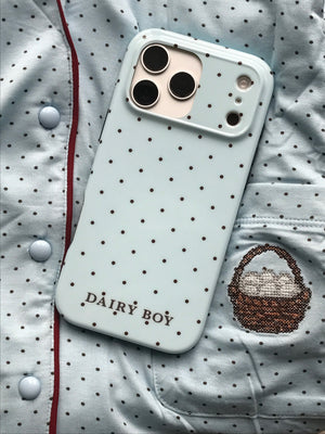 Pale blue phone case with scattered brown dots and "DAIRY BOY" lettering near the bottom, back view with a large camera cutout.