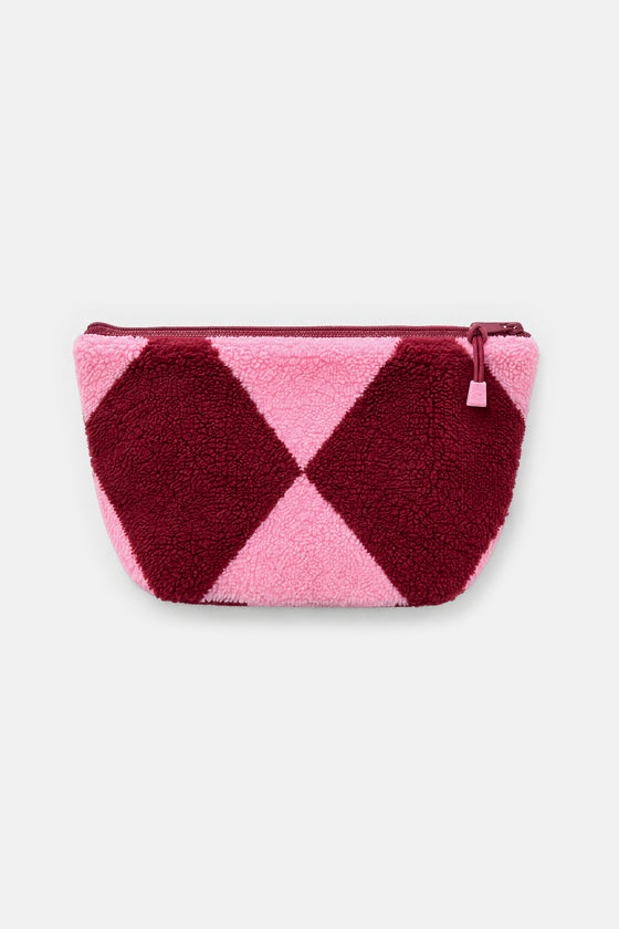A small zippered pouch with a plush teddy texture, featuring a geometric diamond pattern in dark burgundy and light pink, set against a plain light gray background.