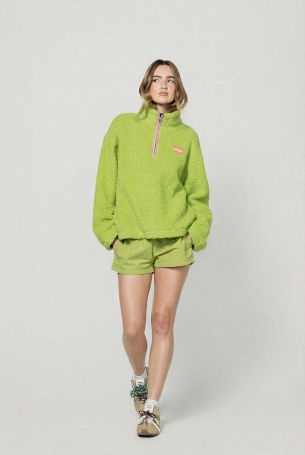 Person wearing a bright green fleece outfit on a white background  |m1