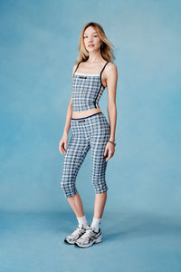 Woman wearing a checkered outfit on a blue background  |M1