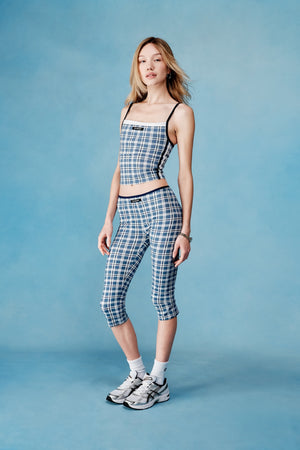 Woman wearing a checkered outfit on a blue background  |M1