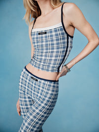 Woman wearing a blue plaid outfit with a white background  |M1