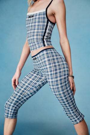 Person wearing a blue and white checkered outfit on a blue background |M1