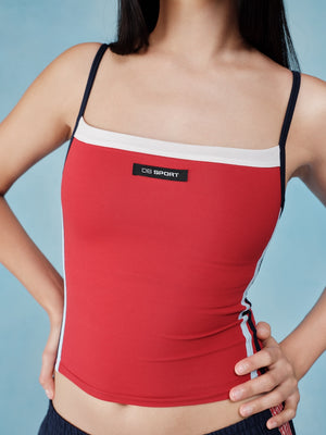 Red sports tank top with white accents and a visible brand logo on a blue background  |M1