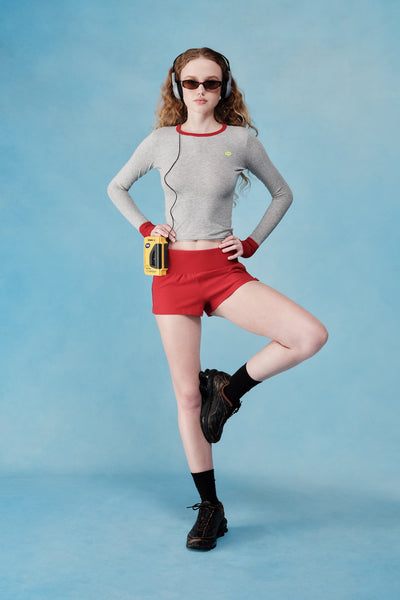 Person wearing athletic gear with headphones on a blue background
