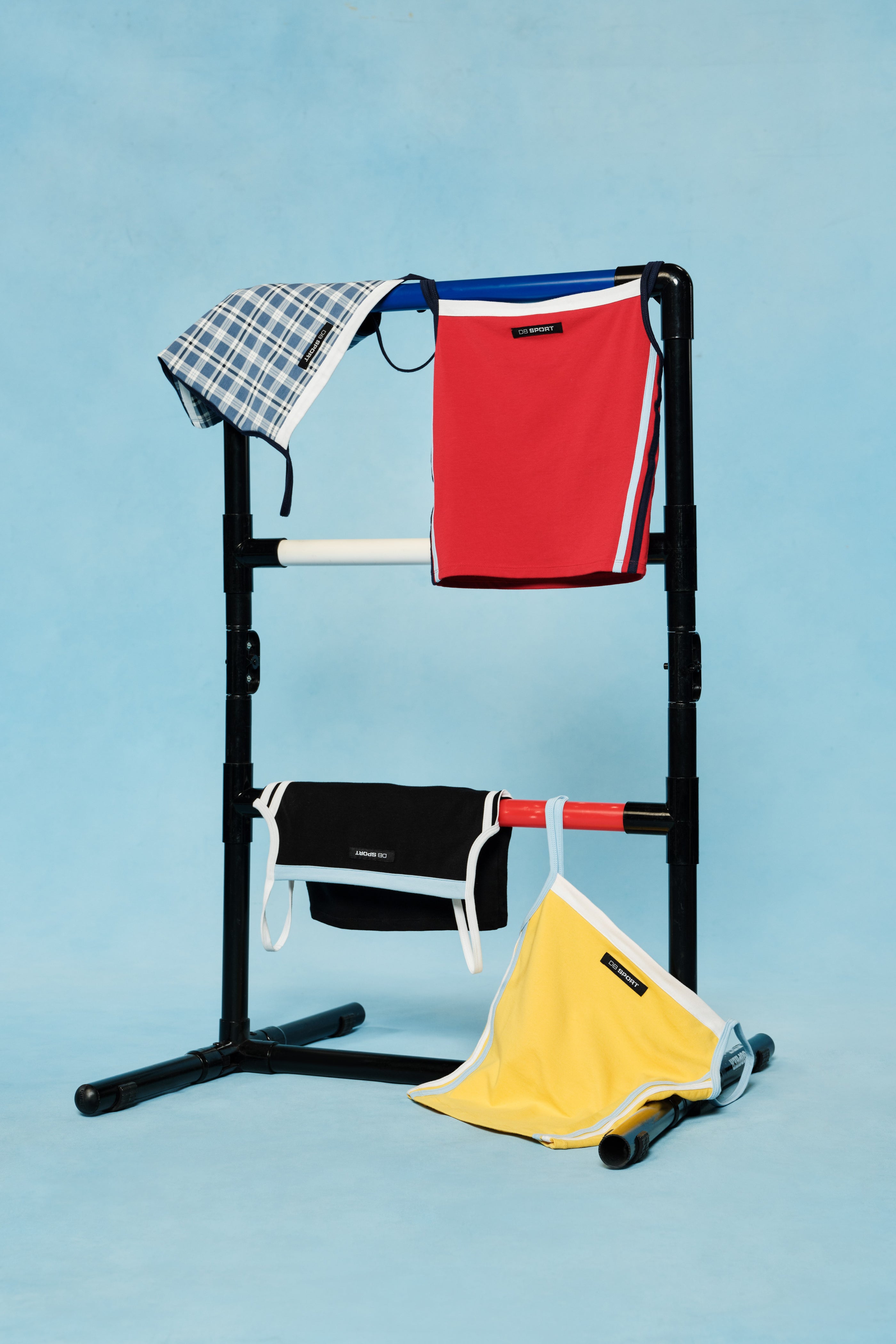 Portable clothes rack with folded clothes on a blue background