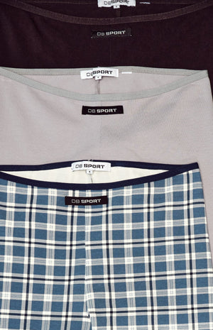 Three pairs of capris with visible brand labels on a white background