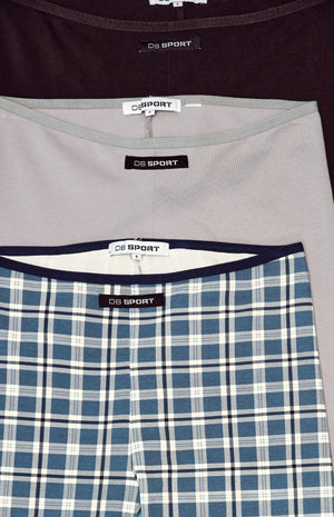Close-up of capris with 'DB Sport' label on a plaid pattern