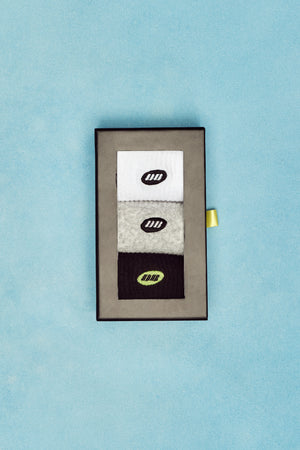 Set of socks in a box with a visible brand logo on a light blue background