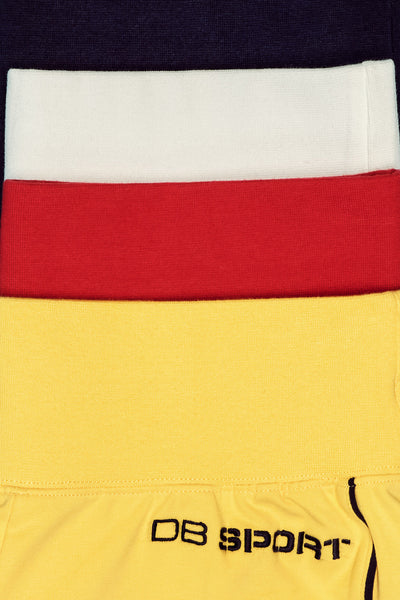 Close-up of a sport shorts with red, white, and yellow sections, featuring 'DB Sport' branding.