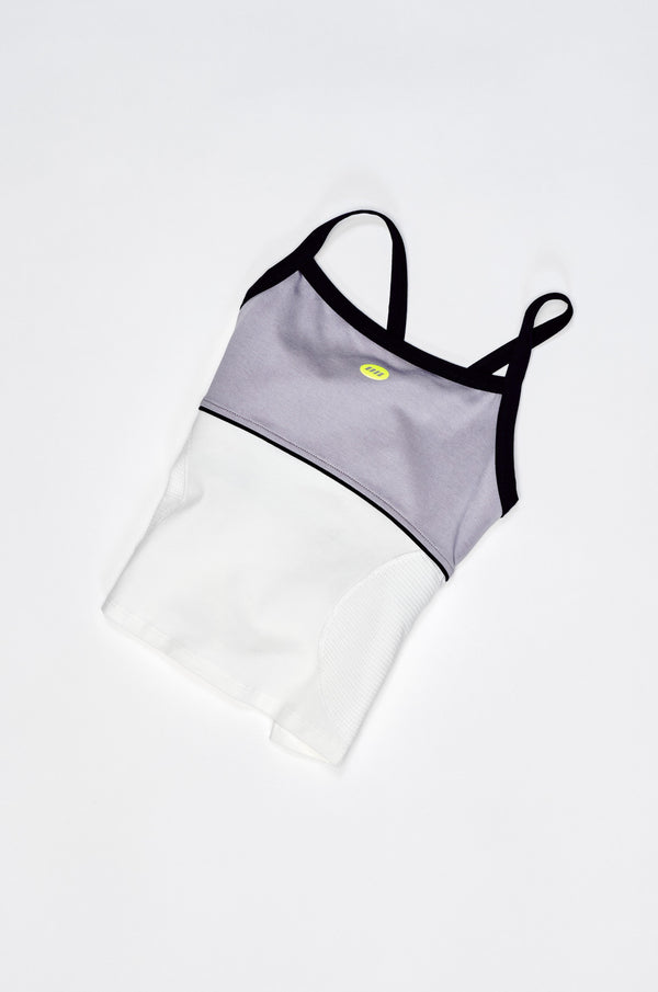 Two-piece swimsuit with gray top and white bottom on a light gray background