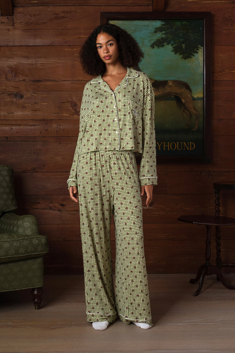 Green and cream gingham pajama set with a small red floral print, white piping, a button-front shirt and wide-leg pants, front view on a model. |M1