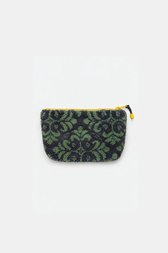 A small zippered pouch with a green and black damask pattern, featuring a bright yellow zipper and pull tab, set against a plain light gray background.
