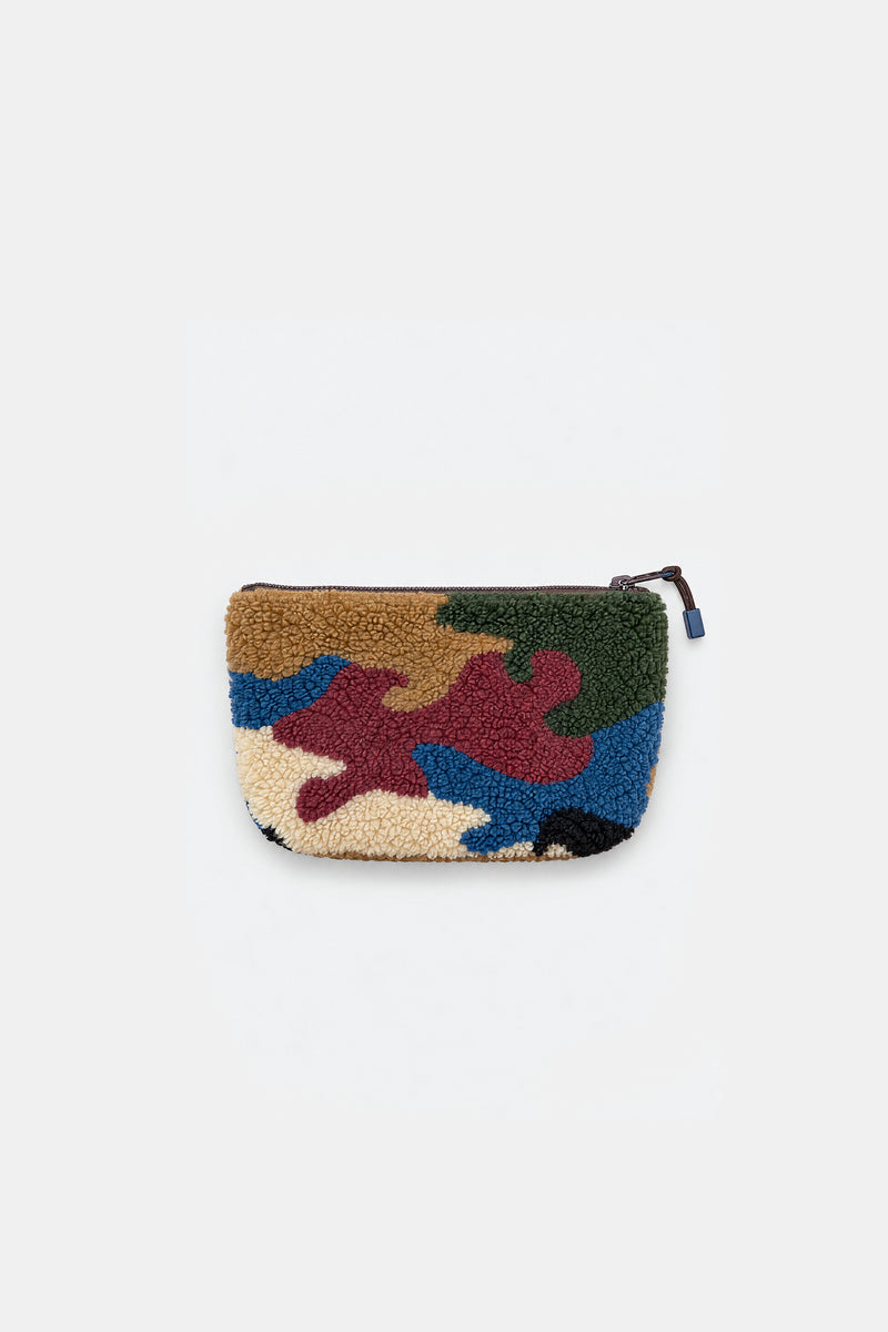 A small zippered pouch with a textured, fuzzy boucle fabric cover featuring an abstract multicolor pattern of blue, green, brown, red, and beige, shown against a plain light gray background.