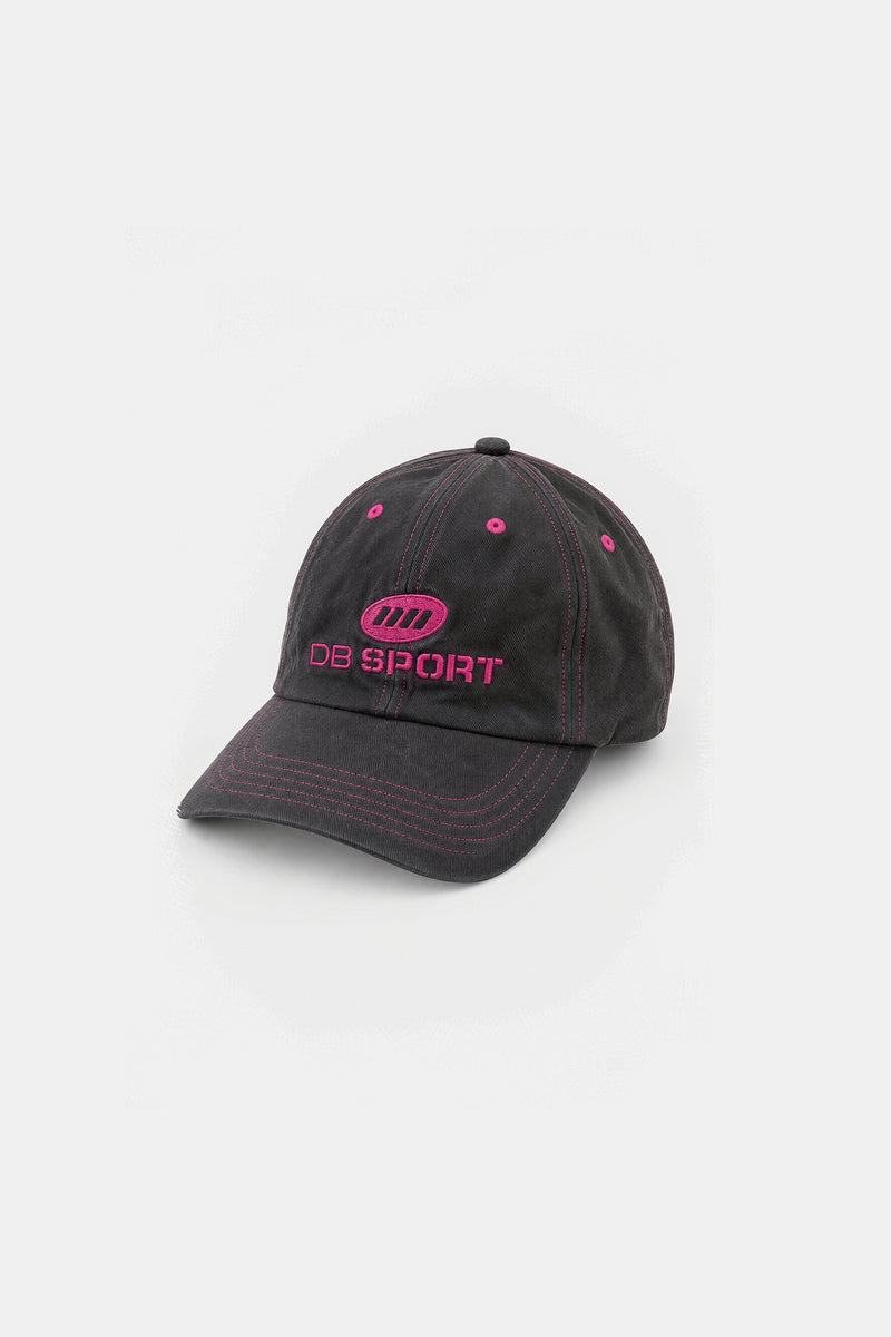 A brown baseball cap with pink contrast stitching and pink embroidered details, including the text 'DB SPORT' and a circular logo on the front, set against a plain light gray background.