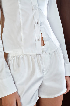 White shirt and shorts set on a plain background
|M1