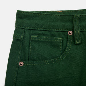 Close-up of green skirt with button and stitching details on a white background