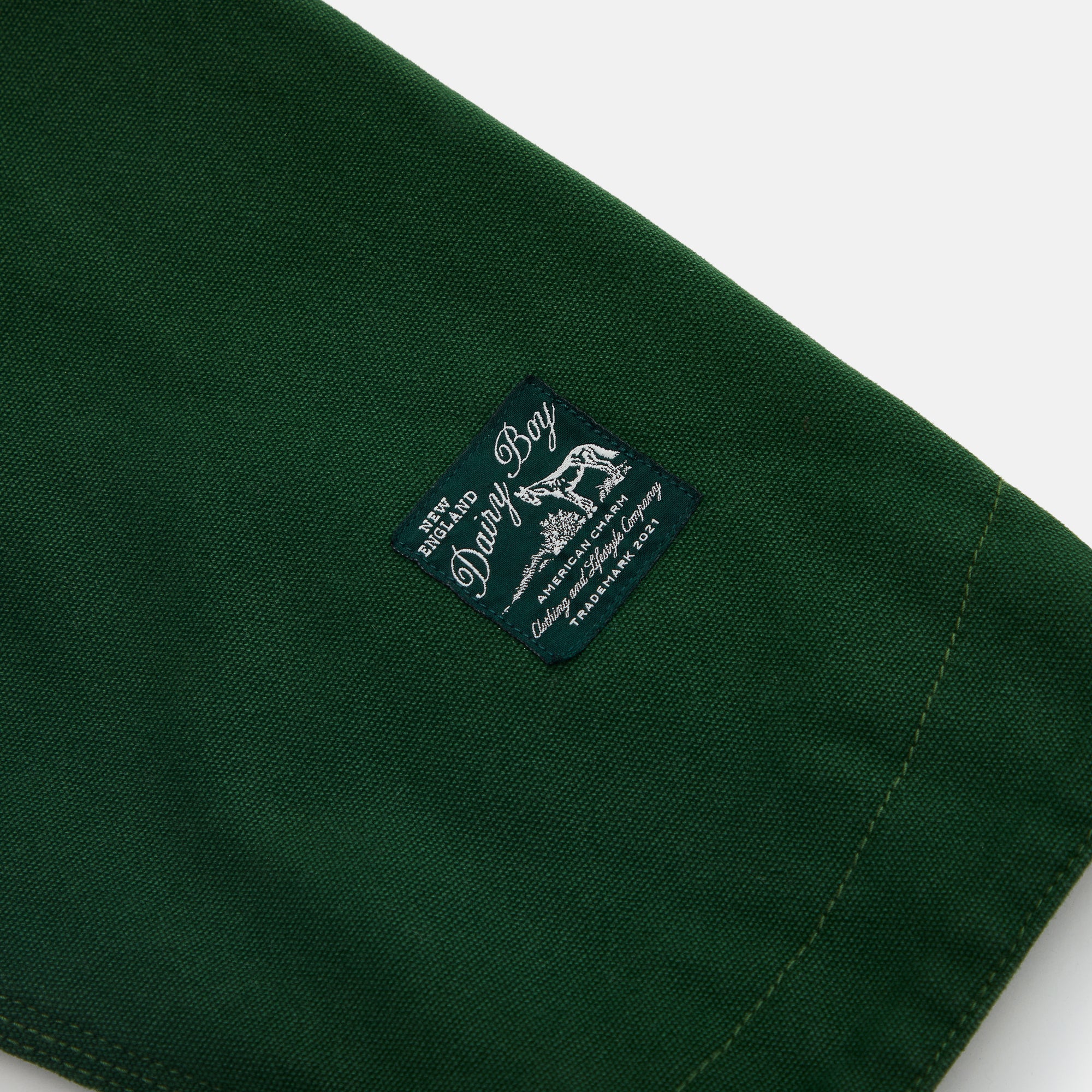Green fabric sleeve with a brand label on a white background