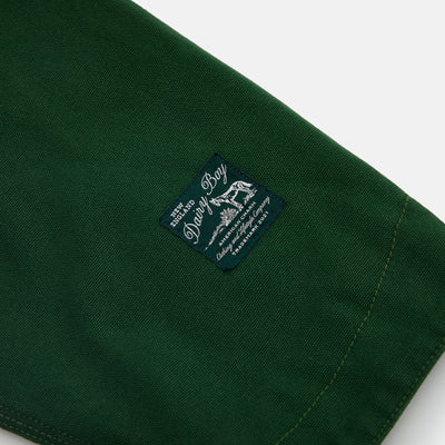 Green fabric sleeve with a brand label on a white background