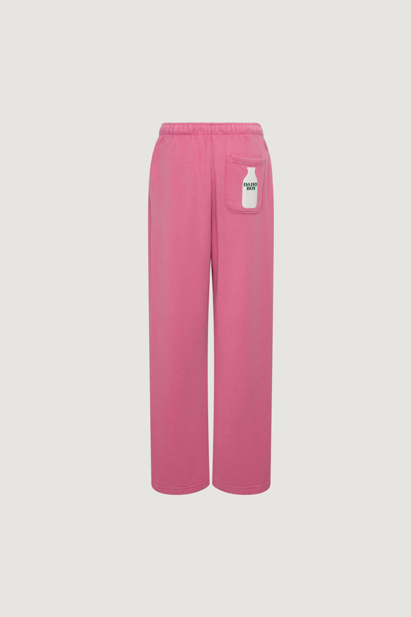 The Dairy Boy Milk Bottle Sweatpant in Strawberry Milk features wide legs, an elastic waistband, and a small white patch with "DAIRY BOY" on the back right pocket. Displayed on a plain white background.