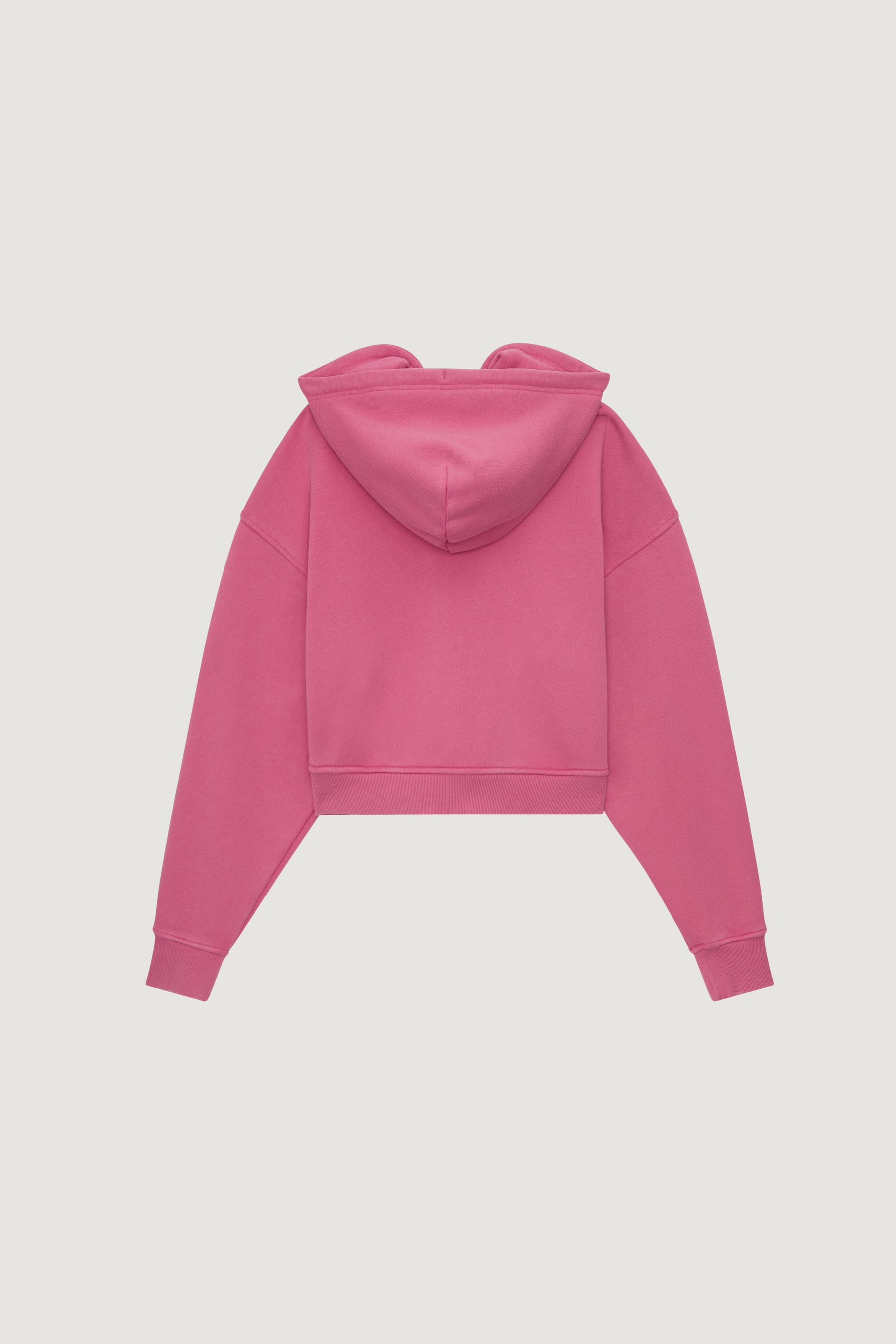The Dairy Boy Milk Bottle Cropped Zip Up in Strawberry Milk is a bright pink cropped hoodie with long sleeves and a hood, shown flat from the back against a plain white background.