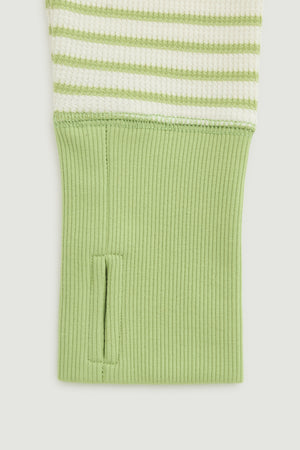 Green and white striped shirt with green cuff on a light gray background