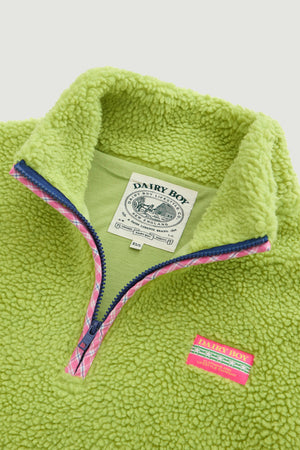 Green fleece pullover with visible brand labels on a light gray background