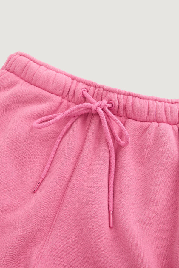 Close-up of the waistband on Dairy Boy’s Milk Bottle Sweatpant in Strawberry Milk, featuring an elastic band and a matching drawstring bow. The fabric looks soft and comfortable.