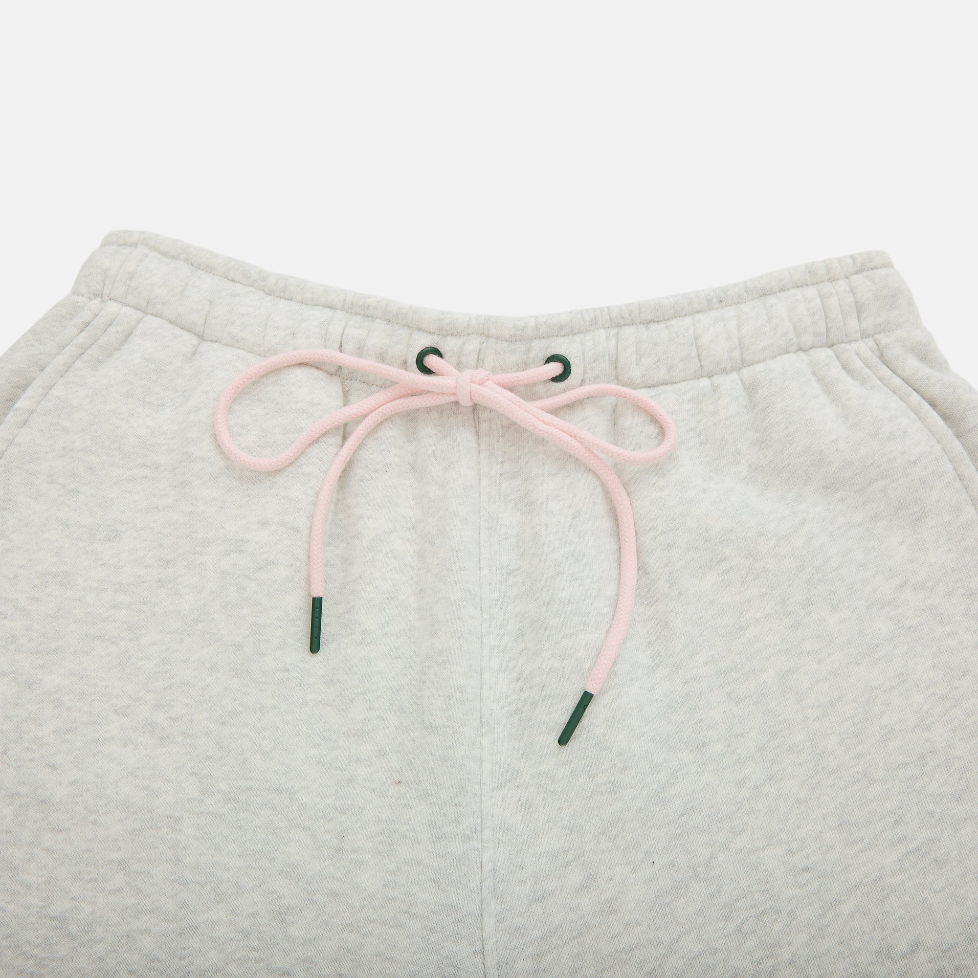 Light gray sweatpants with pink drawstring on a light gray background