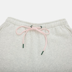 Light gray sweatpants with pink drawstring on a light gray background
