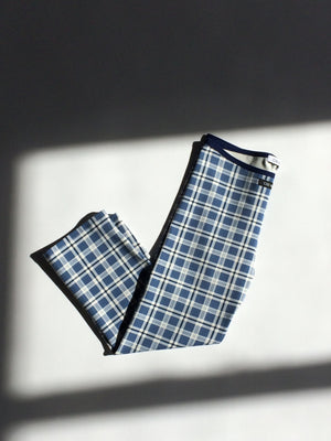 Blue and white checkered fabric on a light gray background