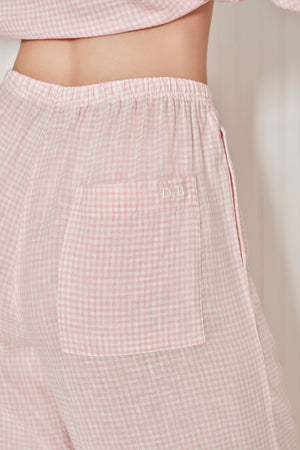 Pink checkered pants with a pocket on a neutral background. |M1
