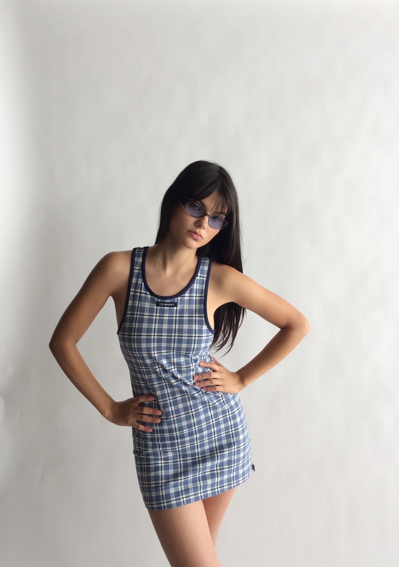 Woman wearing a blue plaid dress against a plain background |M2