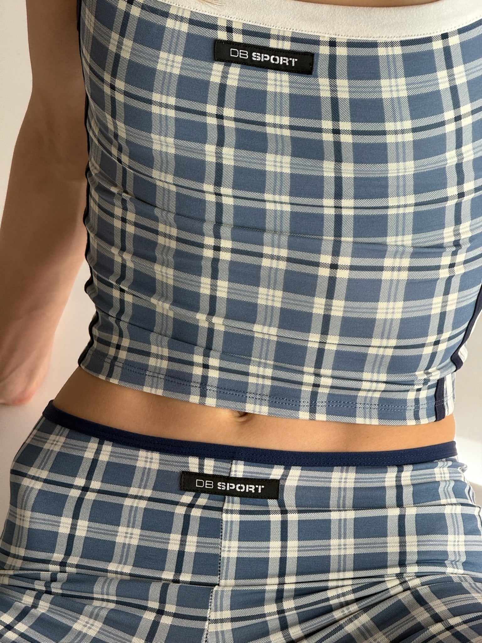 Blue and white plaid tank top and capris with 'DB Sport' label on a neutral background  |M1