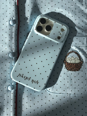 Pale blue phone case with scattered brown dots and "DAIRY BOY" lettering near the bottom, back view with a large camera cutout.