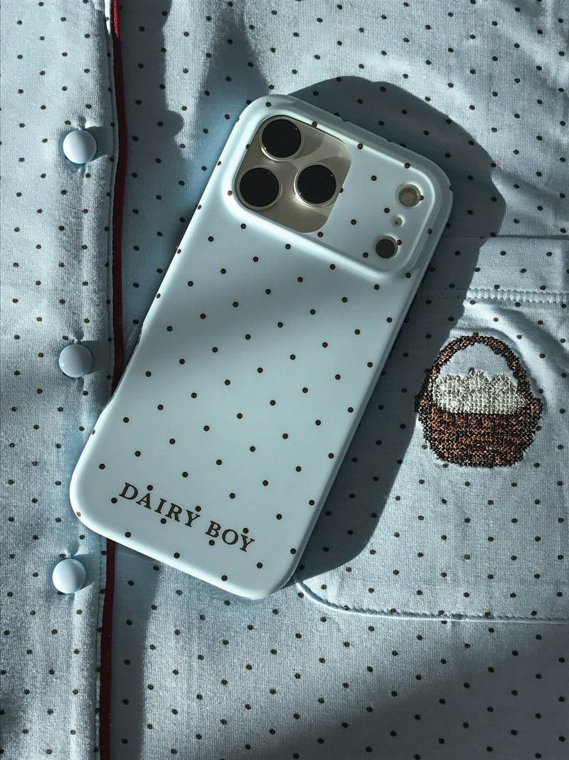 Pale blue phone case with scattered brown dots and "DAIRY BOY" lettering near the bottom, back view with a large camera cutout.