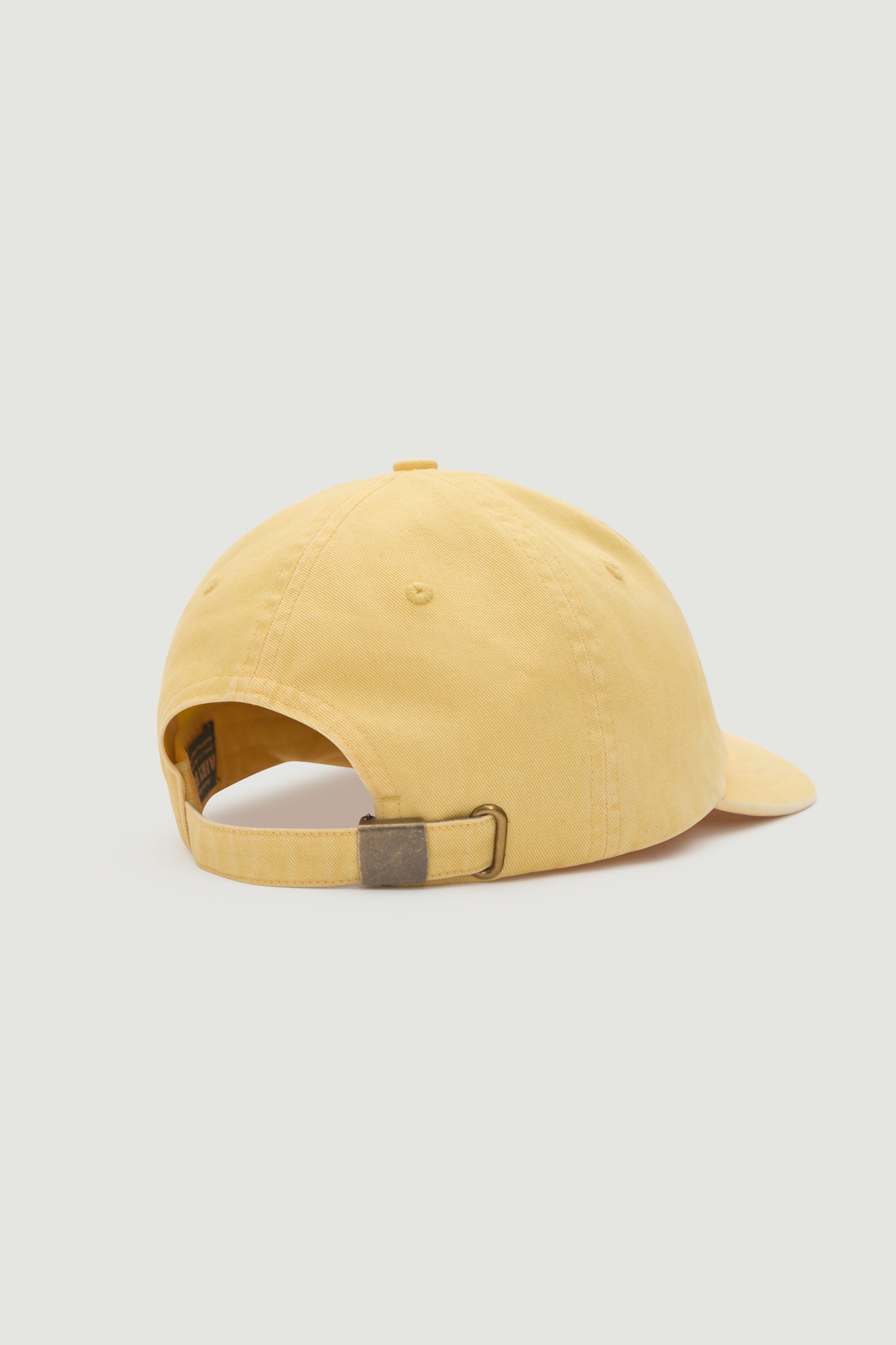 Yellow baseball cap on a light gray background
